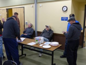 Members of the club talk while waiting for the pizza to arrive