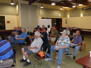 The membership waits for the meeting to start
