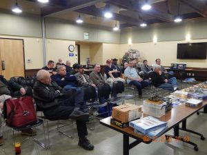 Members of the club wait for the meeting to begin